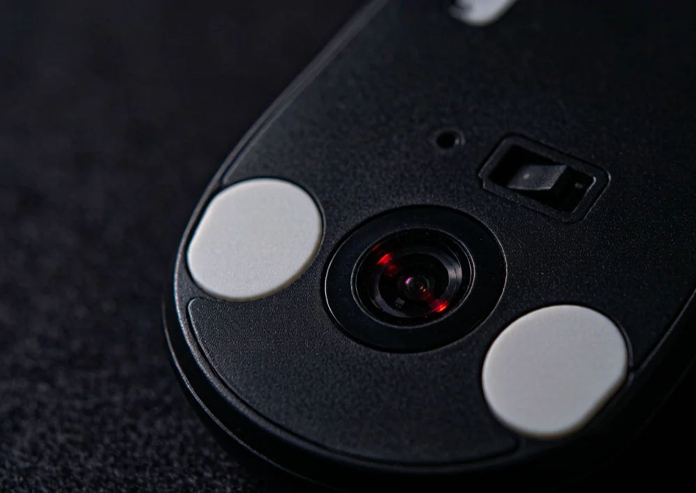 Close-up of the optical sensor on the bottom of a gaming mouse that determines polling rate and tracking accuracy